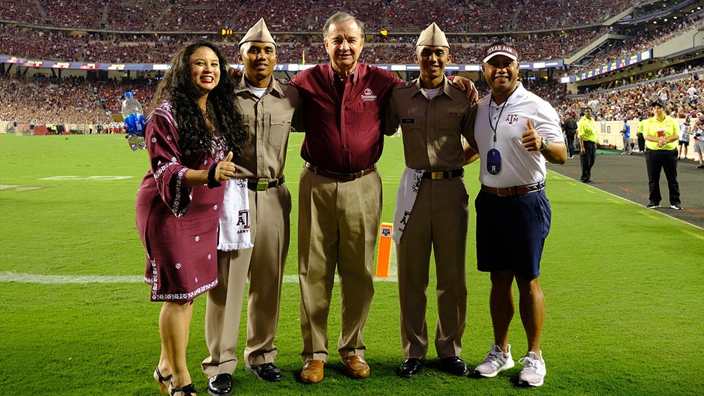 Col. Guieb with family and chancellor John Sharp on Kyle Field