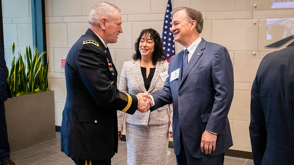 Chancellor John Sharp and Elaine Mendoza, then vice chairman of the Board of Regents, welcome Gen. Mike Murray to the Texas A&M University campus.