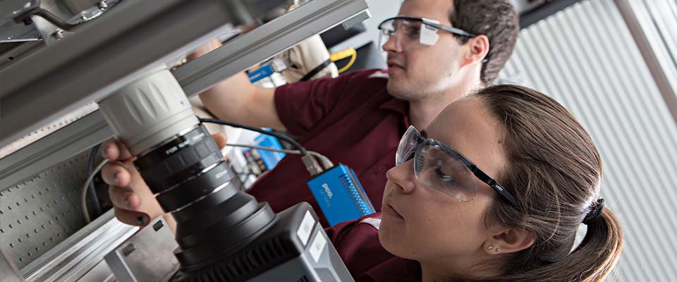 Two former Texas A&M University doctoral students in the chemistry and mechanical engineering programs work together in the university’s National Aerothermochemistry and Hypersonics Laboratory.