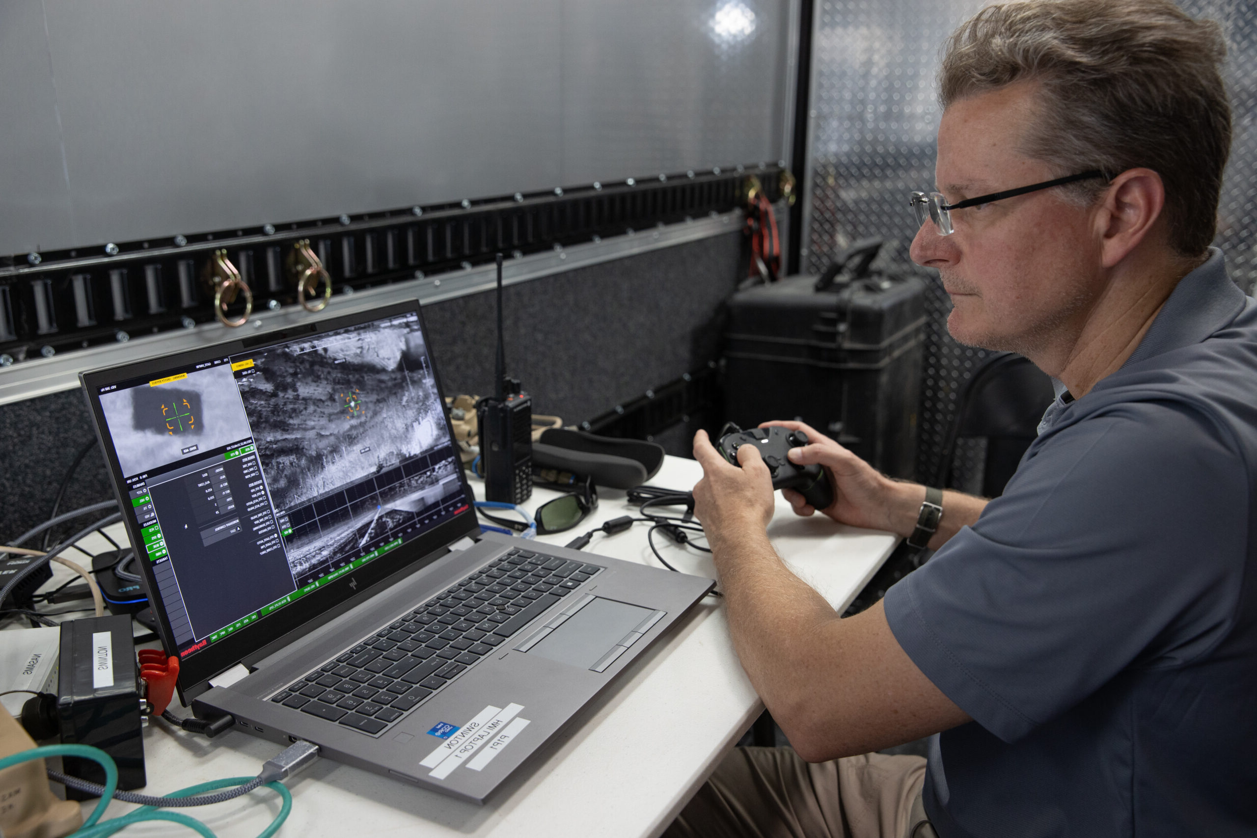Raytheon technician looking at a computer screen.